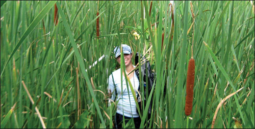 Keala Cummings peers through cutting grass - photo by Lora Harris